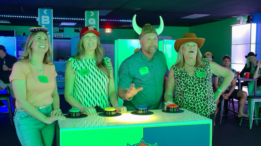 A team at the buzzers under green light, one player in a viking helmet