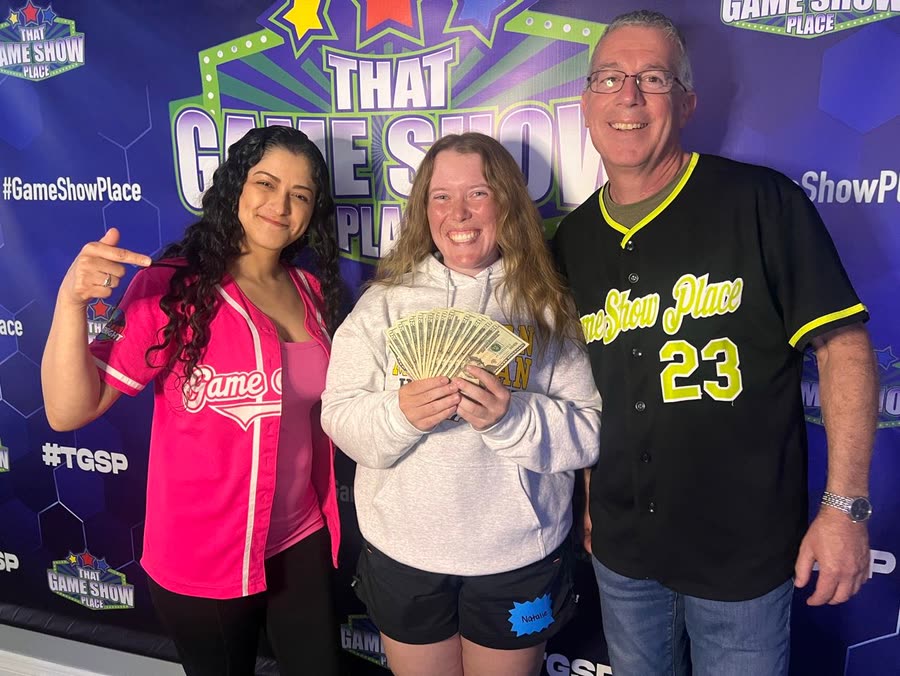 A player collecting a cash prize