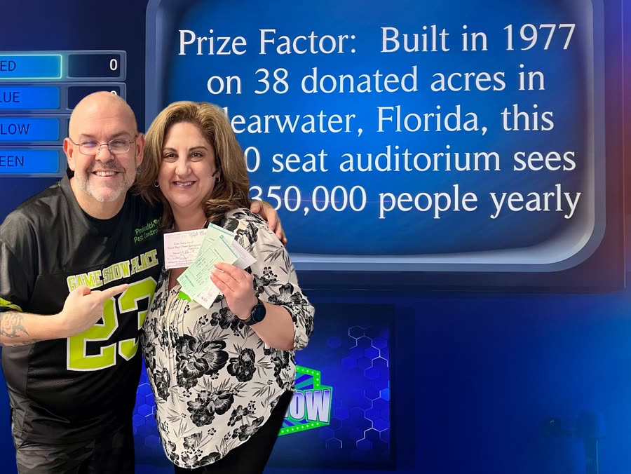 A winner holding their prize at the studio